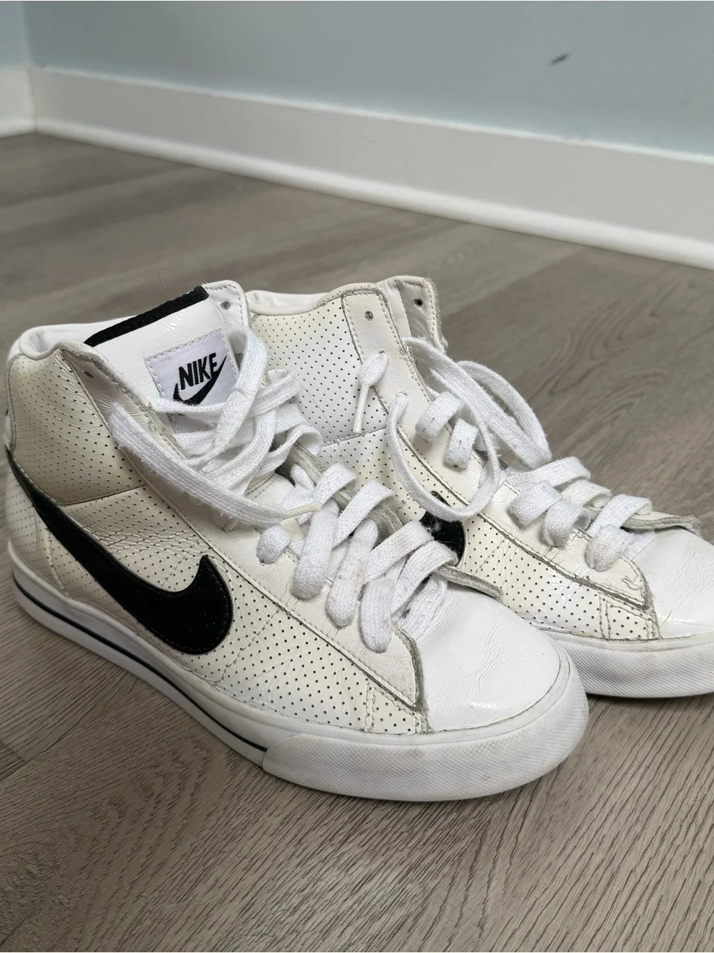 Nike Women's White High-Top Sneakers with Black Swoosh